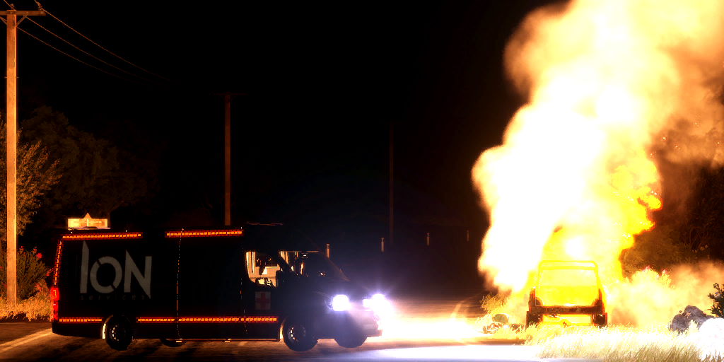 The destroyed truck with first responders in the foreground